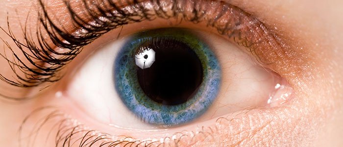 Close up of a dilated pupil on a blue eyeball