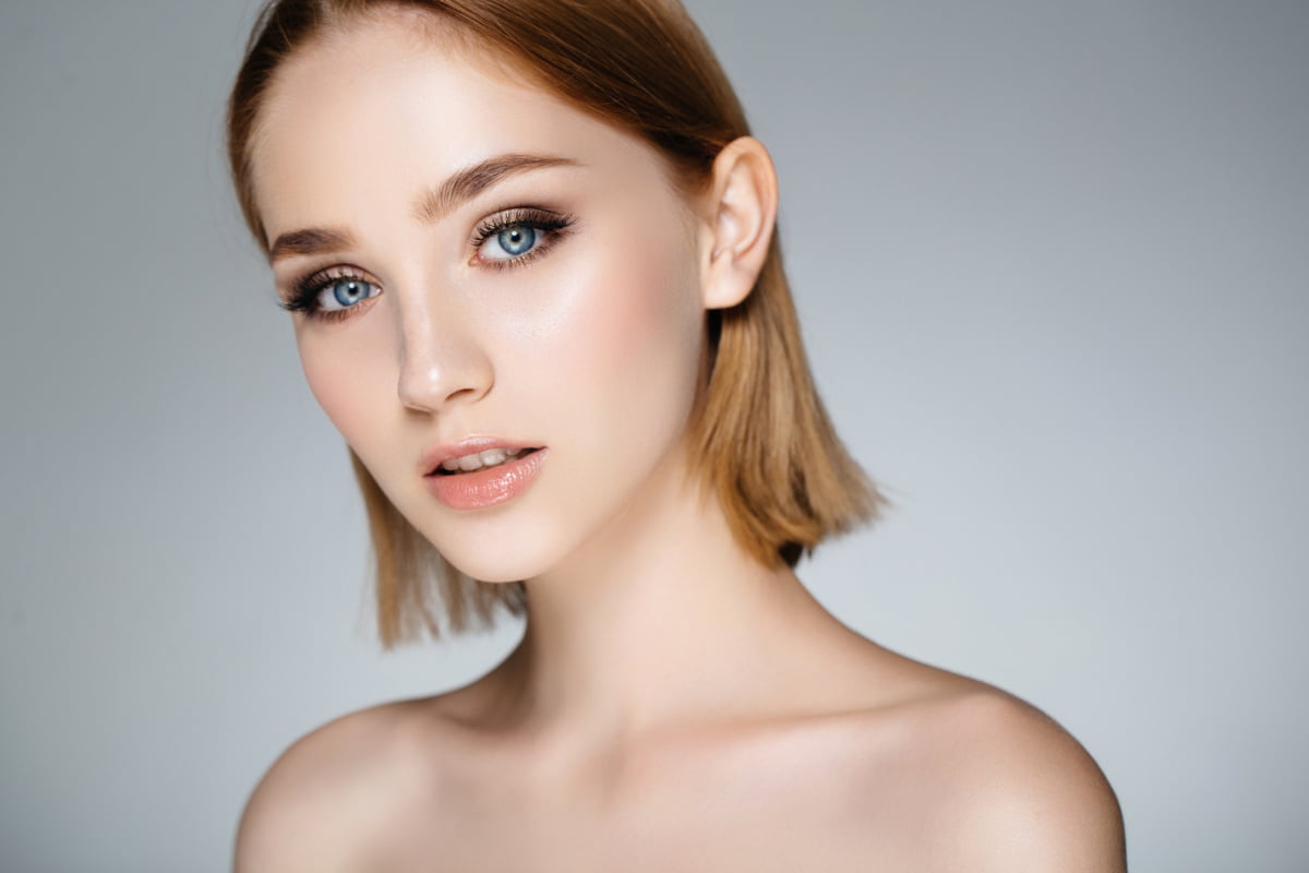 Young woman with blond hair shown from the shoulders up