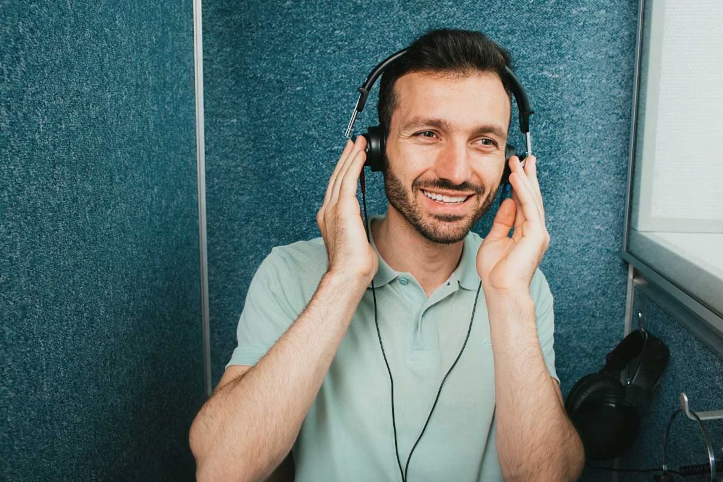 young dark haired male taking a hearing test