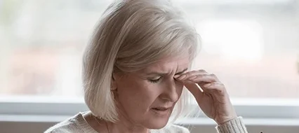 Older woman rubbing her eyes