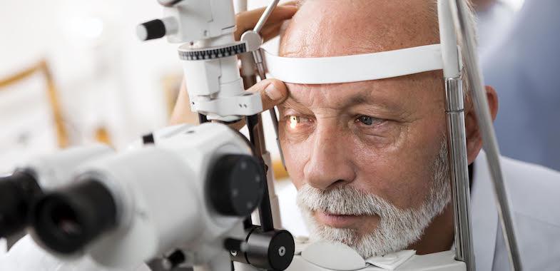 elder man getting an eye exam at the eye doctor