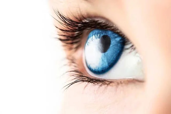 A girl with blue eyes zoomed in on her eyeball