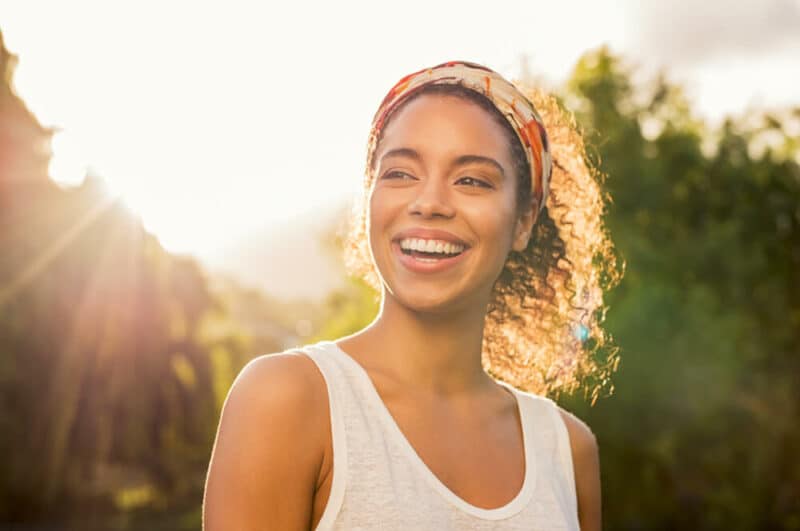 women with short hair smiling outdoors