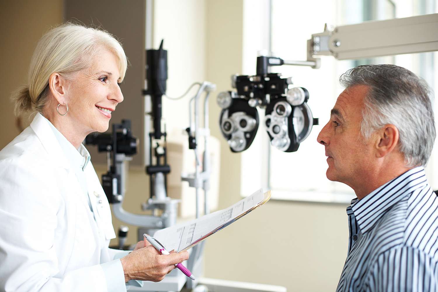 older male patient speaking to an eye doctor