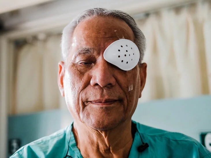 man wearing an eyepatch after eye surgery