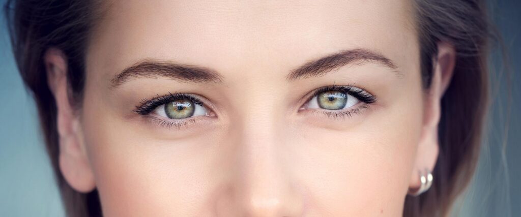 Close up of female with dark hair and green eyes