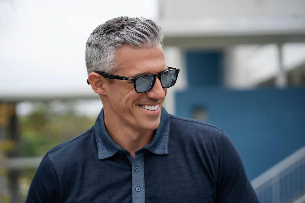 Middle aged man wearing sunglasses and smiling