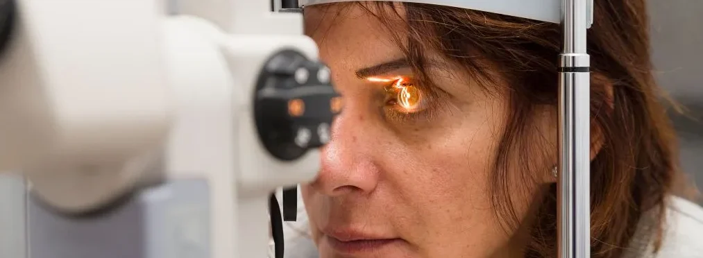 woman getting her eyes scanned for cataracts