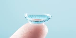 a contact lens sitting on top of a fingertip