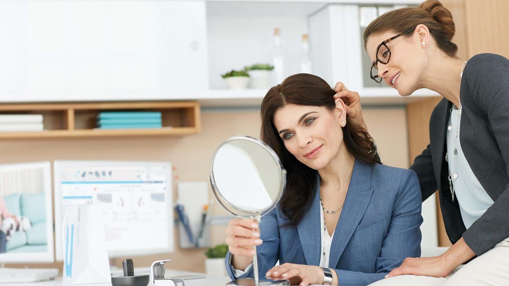 Woman has hearing aid fitted to her ear