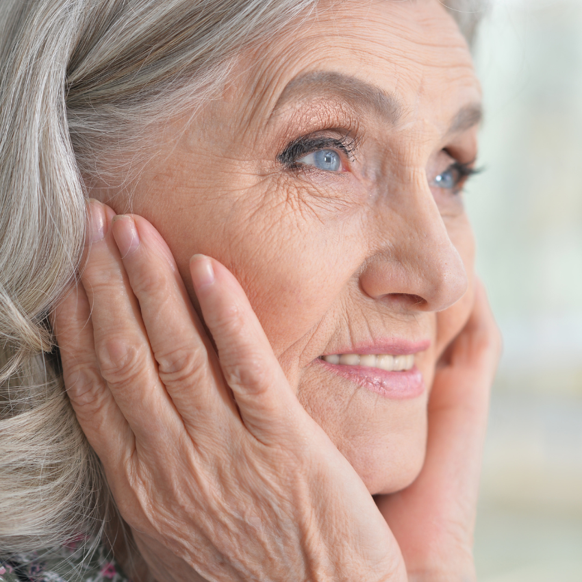 Close up portrait of smilling beautiful senior woman posing at home