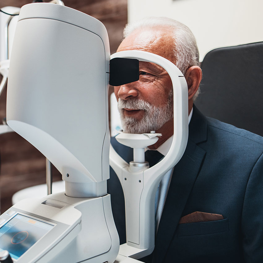 Elegant-senior-bearded-man-receiving-ophthalmology-treatment.-Doctor-ophthalmologist-checking-his-eyesight-with-modern-equipment.