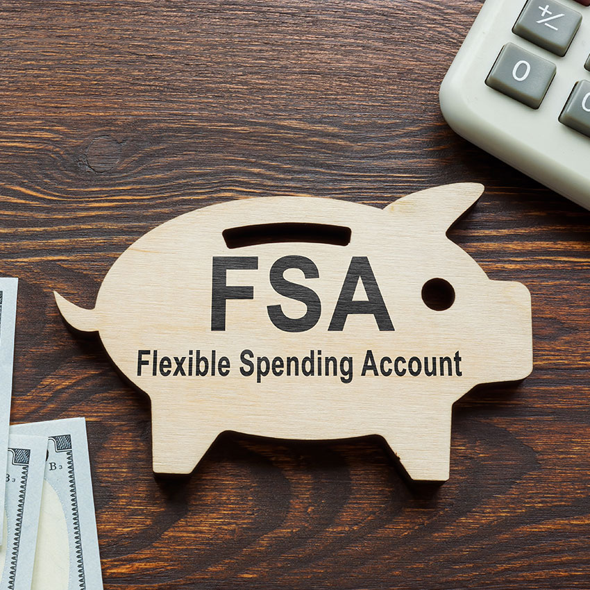 FSA-flexible-spending-account-words-on-the-wooden-piggy-bank.