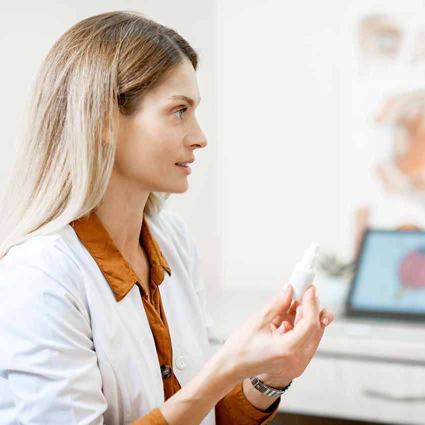Female-ophthalmologist-with-eye-medicine-in-the-dropper-during-medical-consultation-at-the-ophthalmologic-office