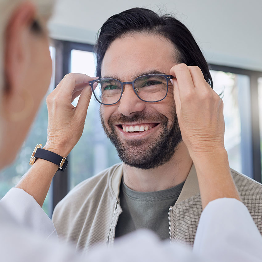 Optometrist,-glasses-and-man-with-smile-in-store-for-vision,-eyesight-and-optical-frames