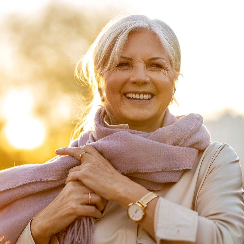 Senior-woman-enjoying-autumn-colors-at-sunset