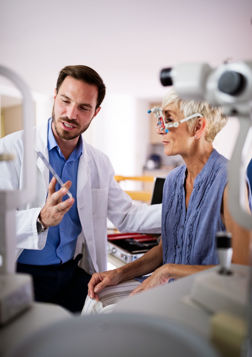 Optometrist examining senior woman in modern ophthalmology clinic