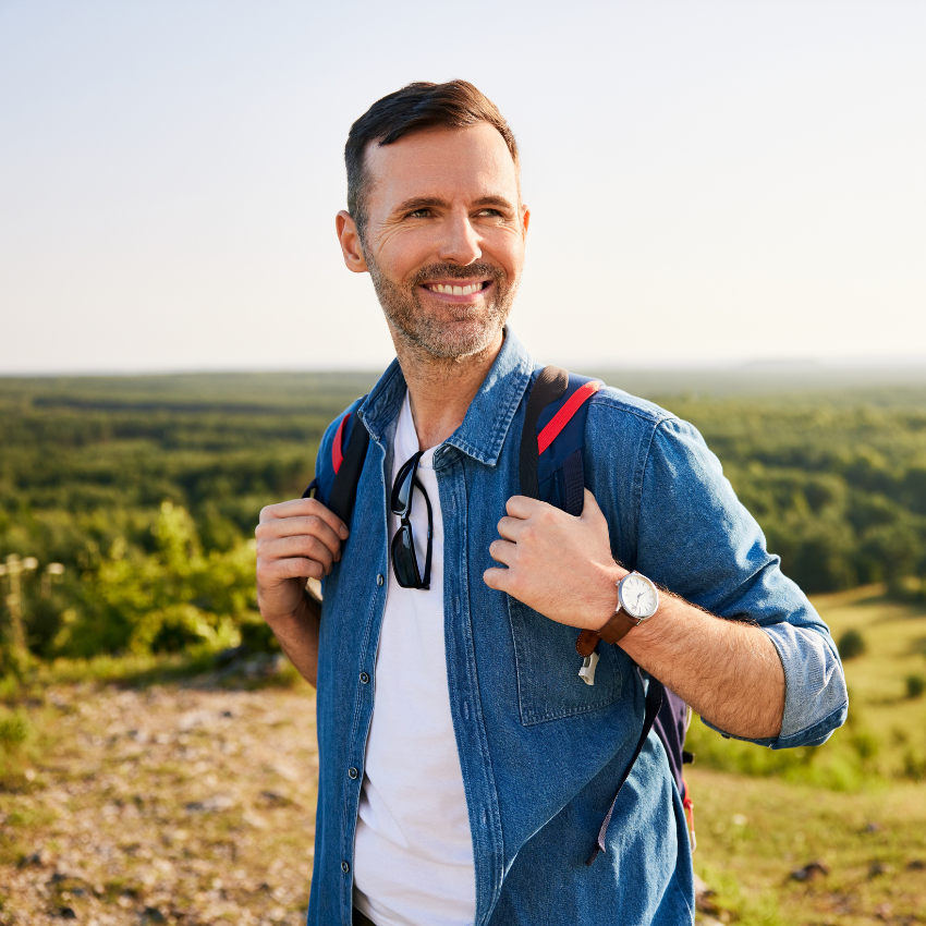 Smiling mid adult man hiking
