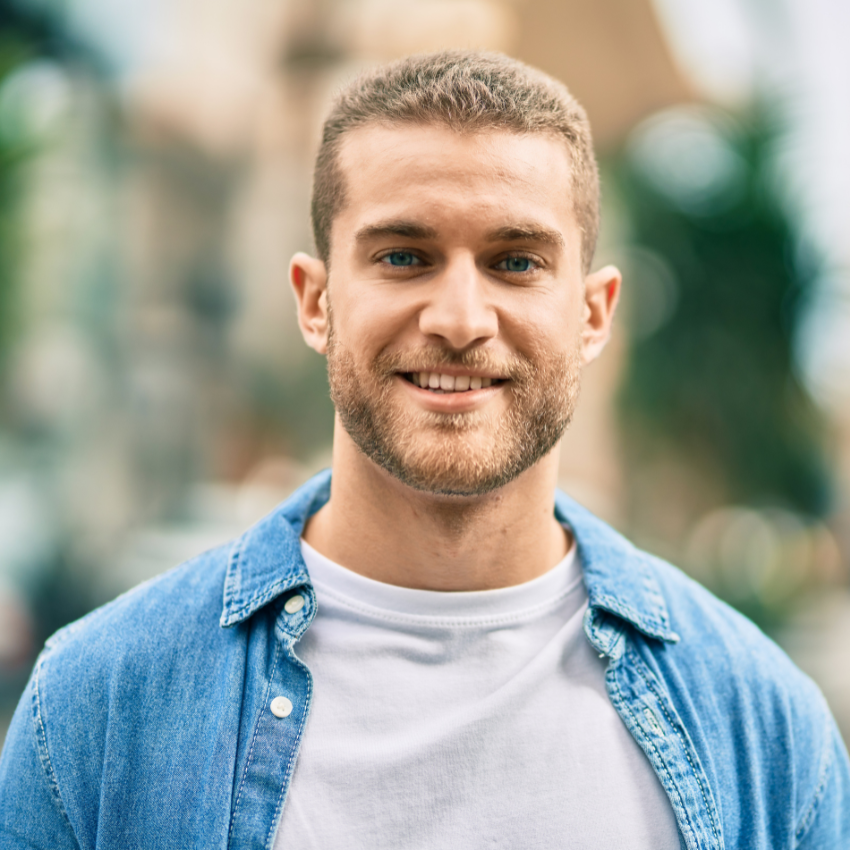 Young caucasian man smiling happy standing at the city.