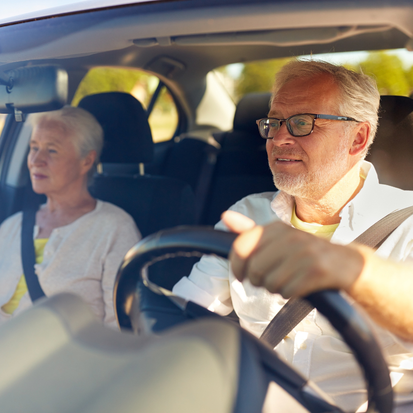 road trip, travel and old people concept happy senior couple driving in car