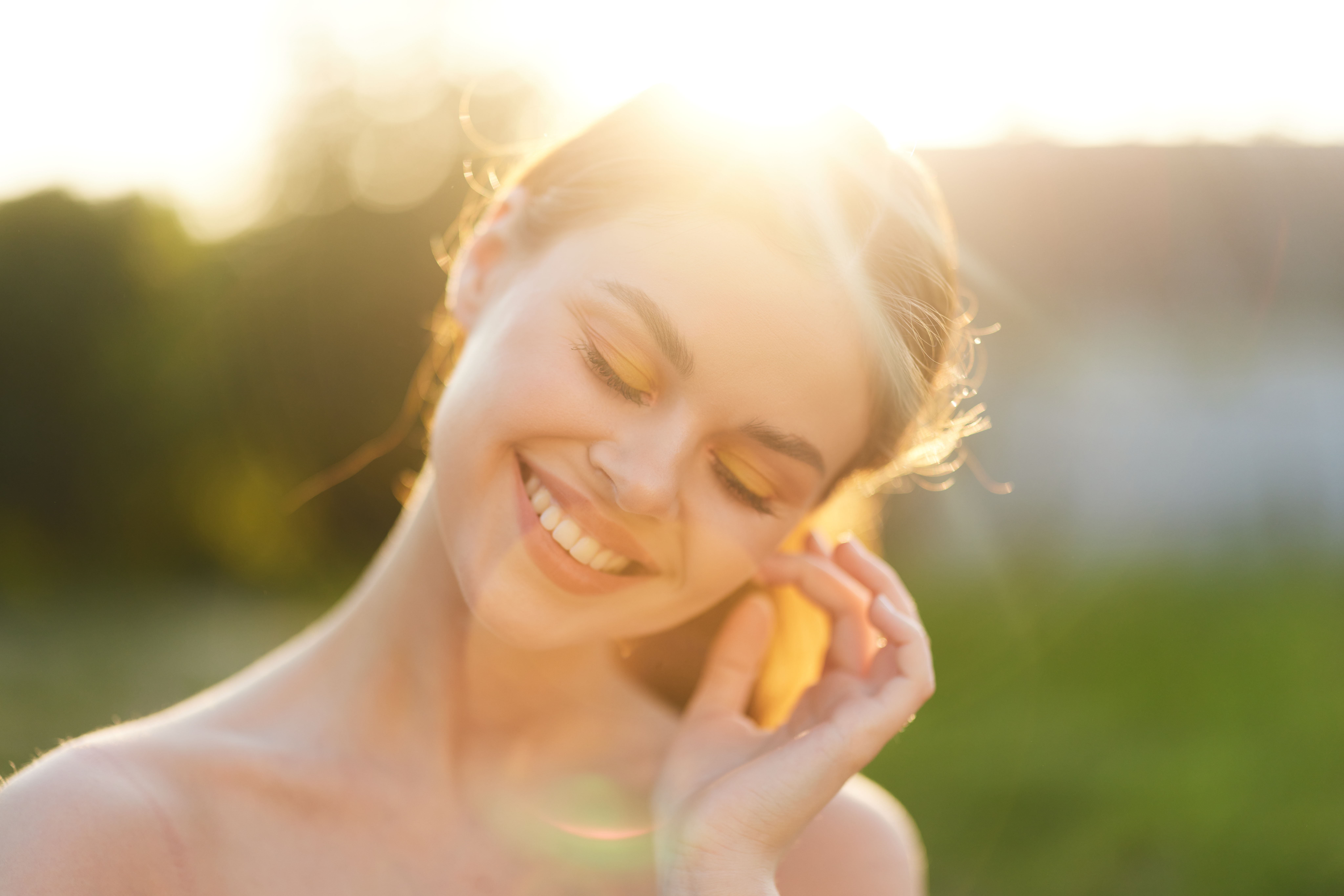 Young,Woman,Enjoying,A,Sunny,Day,Outdoors,,Smiling,Gently,With