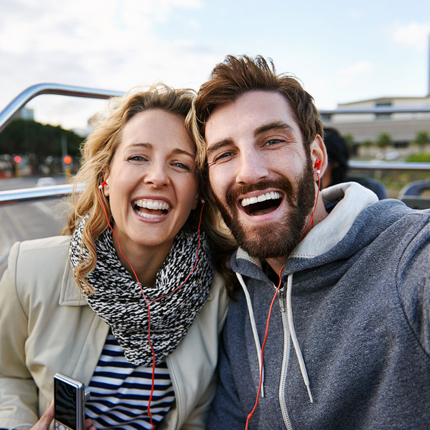 tourist-couple-travel-selfie-on-open-top-tour-bus-in-city