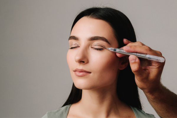 Upper Blepharoplasty. Surgeon is drawing marking lines on eyelid of patient to have accurate operation. Surgeon is planning process of upper blepharoplasty with marker