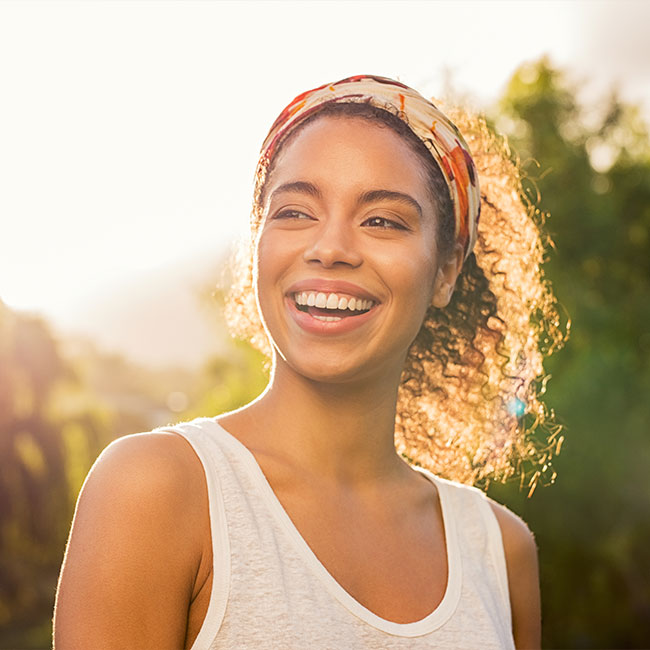 Young-african-woman-smiling-at-sunset