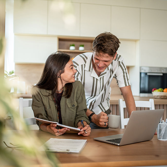 Young-couple-planning-finances-together-at-home-kitchen