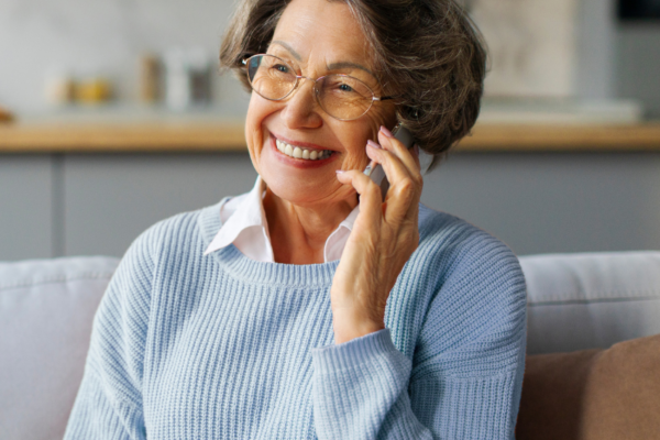 Elderly woman on phone smiling