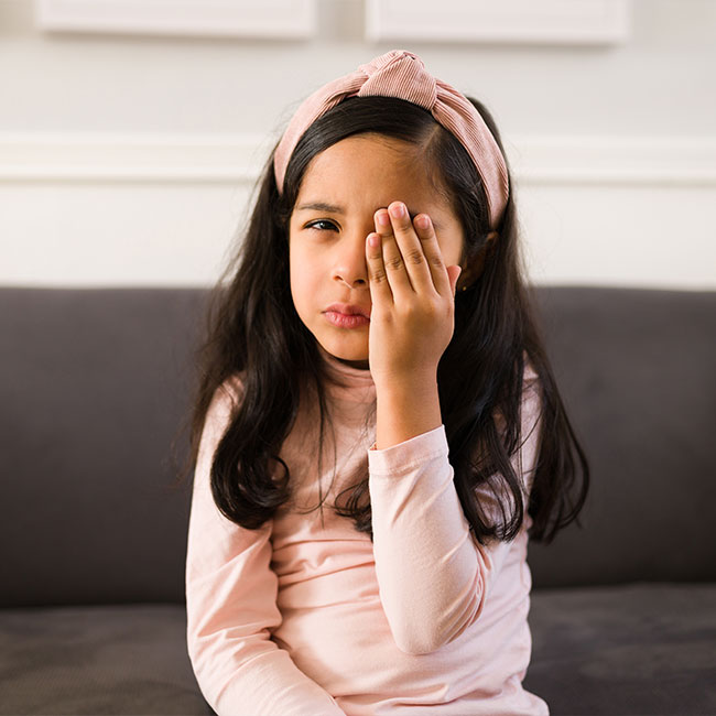 Sad-elementary-girl-with-conjunctivitis