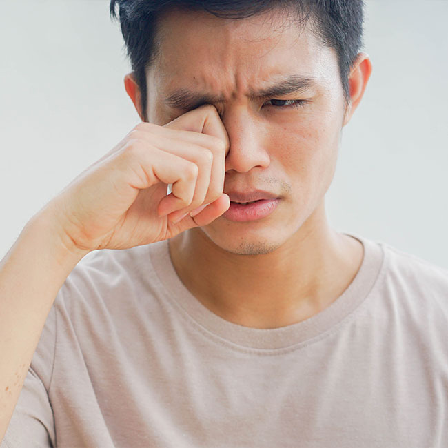 close-up-young-man-using-hand-to-rubs-eye-after-feeling-uncomfortable-sensation-for-health-care-concept