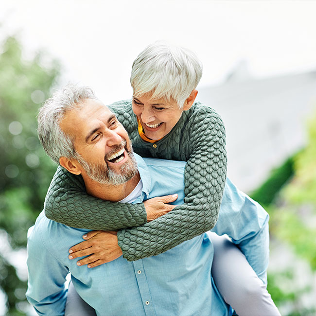woman-man-outdoor-senior-couple-happy-lifestyle-retirement-together-smiling-love-piggyback-active-mature2