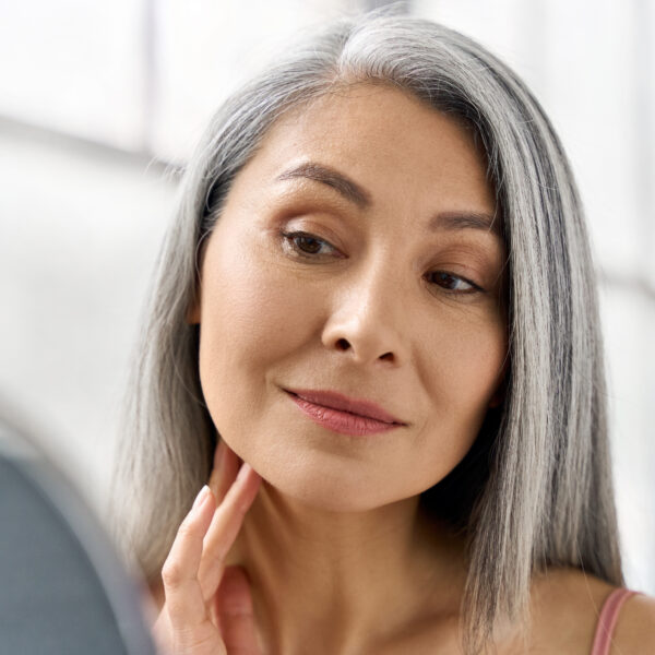 Woman looks into mirror