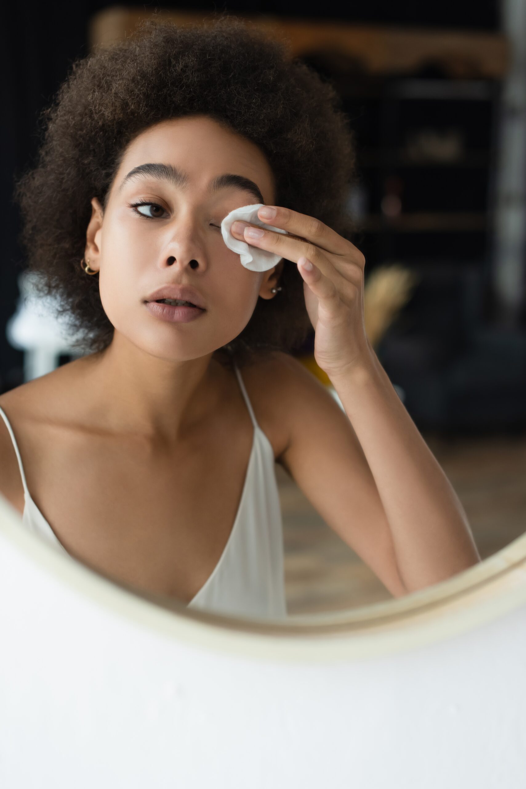 Young Woman Cleans Eye With Cotton Pad