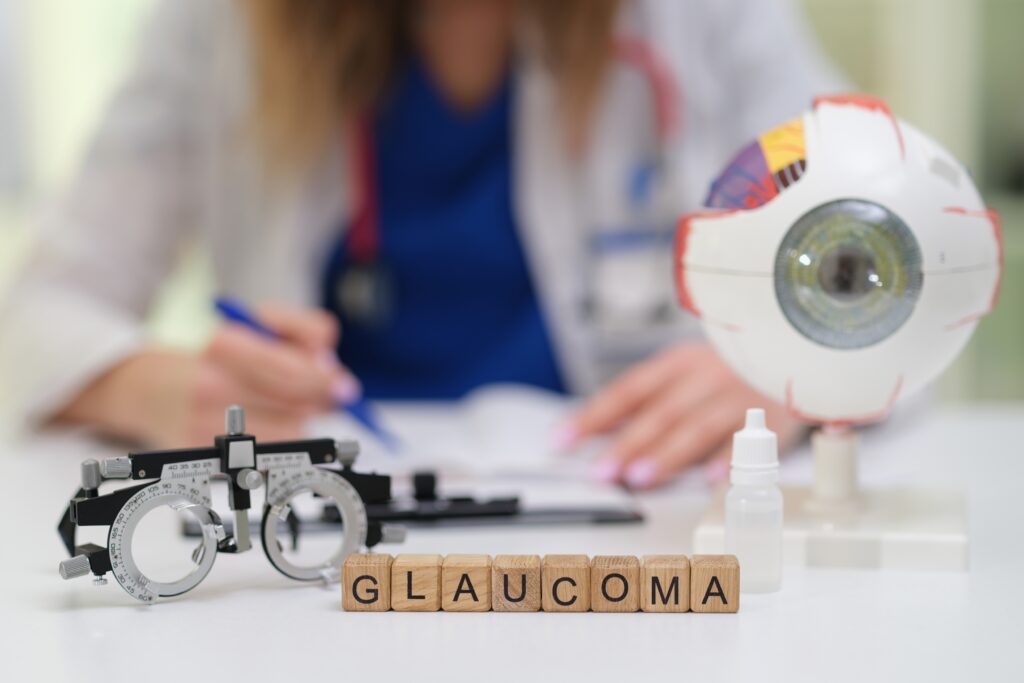 Eye doctor at desk with blocks spelling out glaucoma