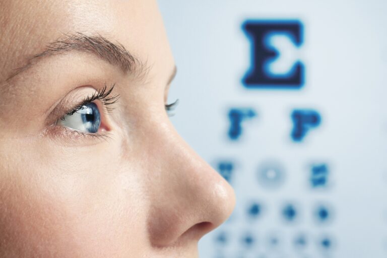 Eye doctor performing a comprehensive eye exam and vision test.