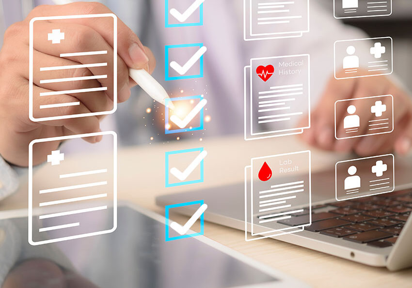 EHR,-checklist-Doctor-taps-tablet-beside-laptop-to-review-medical-records-and-patient-data-privacy