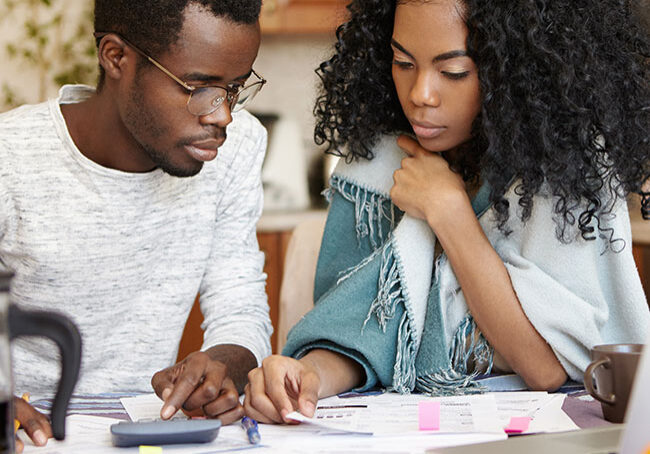 Indoor-candid-shot-of-young-African-American-couple-doing-paperwork-together