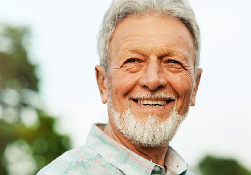 Elderly man smiling outside