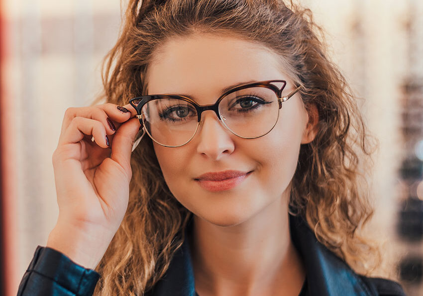 View-of-a-young-attractive-woman-trying-glasses-at-the-optician.
