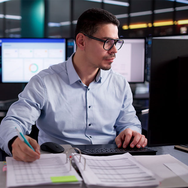 Accountant Electronically Calculating Invoices